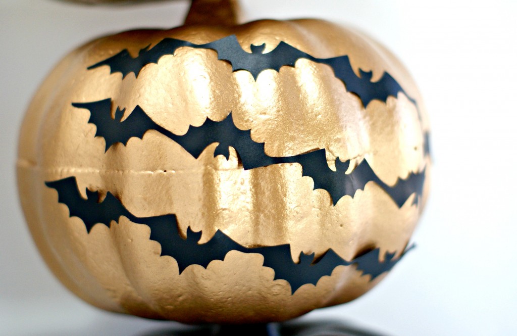 Spray painted gold dollar store pumpkin w/ vinyl bats for Halloween